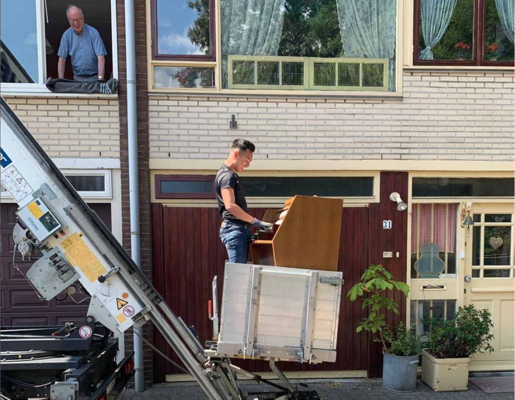 Verhuislift en operator met piano en een blije klant!